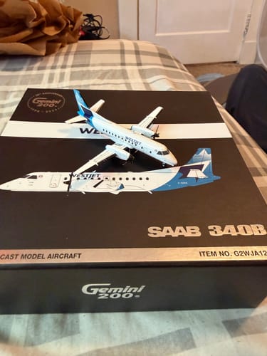 Customer's Gemini200 WestJet SF-340 model airplane shown on top of its black packaging box.