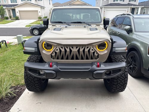 Customer's Shark Grille painted tan to match their Jeep Wrangler, shown on the front of the vehicle.