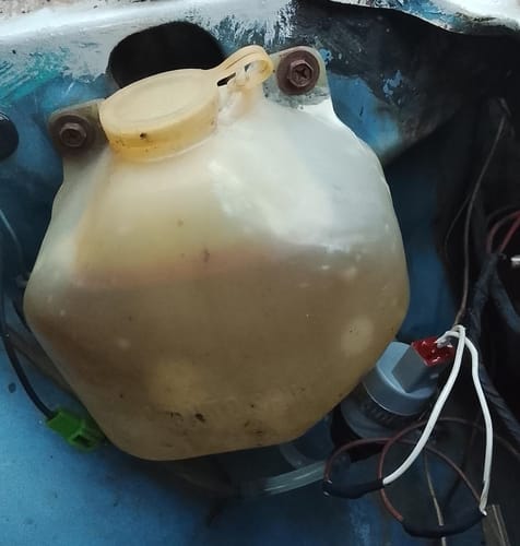 Customer's new windscreen washer pump installed on the fluid reservoir in their Datsun Stanza.