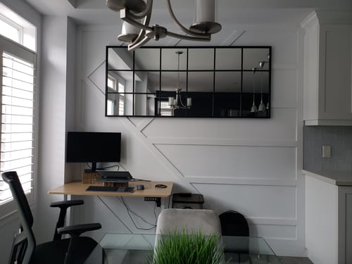 Reviewer's Modern Black Grid Wall Mirror hung horizontally on a white accent wall above a desk.