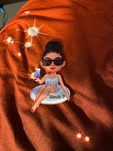 Customer's personalized 'Girl On Float' cruise magnet, customized with the name 'Wanda P', on a patterned fabric.
