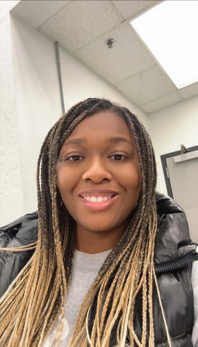 A customer with clear, glowing skin smiles after using the Brighten and Glow Serum.