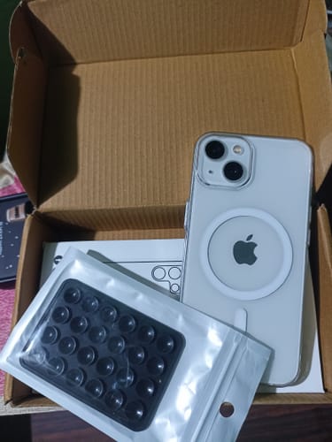 Customer's clear Anti Yellow Magsafe Case on a white iPhone 13, displayed with accessories from the box.