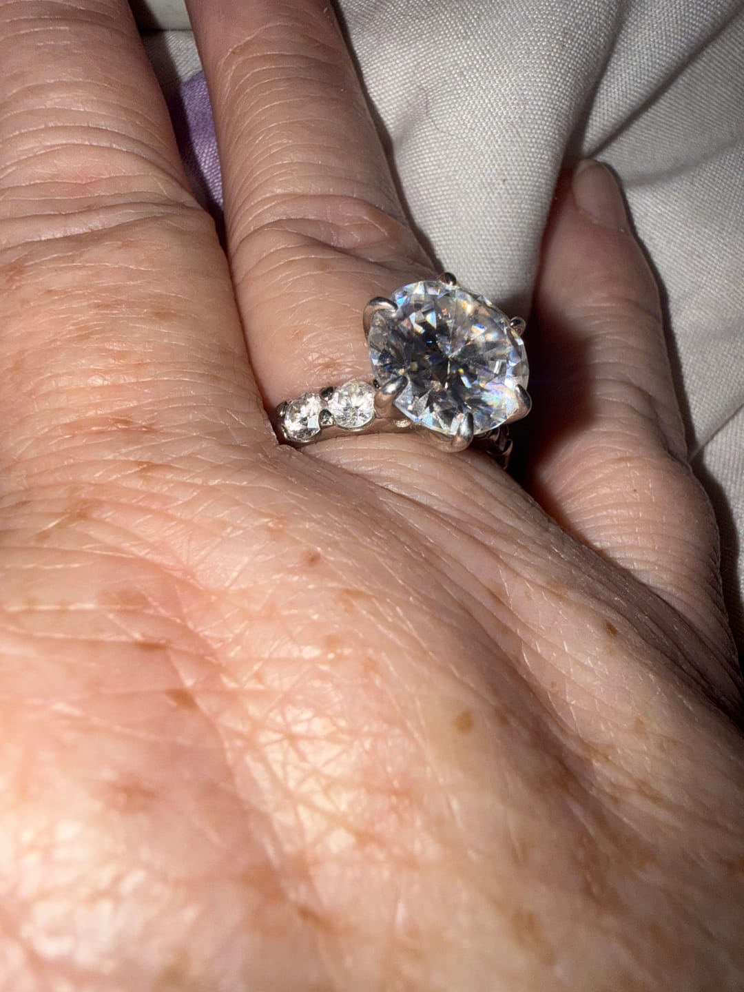 Customer photo review of S925 Moissanite 6.0Ct Round Cut Center Stone With Moissanite 4.0Ct Band Stone Engagement Ring Travel Ring In Sterling Silver