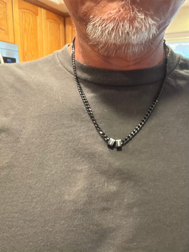 Customer wearing the dark steel Legacy Necklace with two personalized beads.