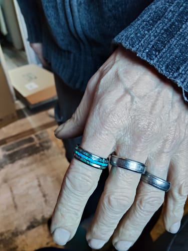 Customer's hand showing the Vanguard ring with its bright blue inlay, alongside two other silver rings.