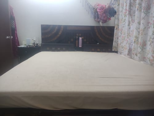 Customer's Flo Anti-Gravity™ Mattress on a bed, covered with a light-colored fitted sheet.
