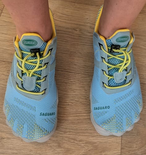 Customer shows a top-down view of their light blue and yellow Free I - Barefoot Shoes on a wooden floor.