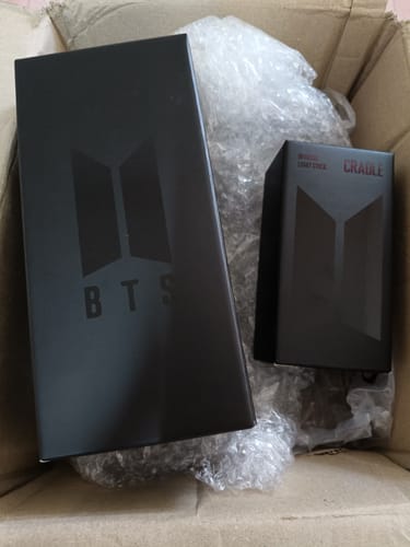 Customer's BTS Official Light Stick Ver.4 and Cradle in their original black boxes inside a shipping box.