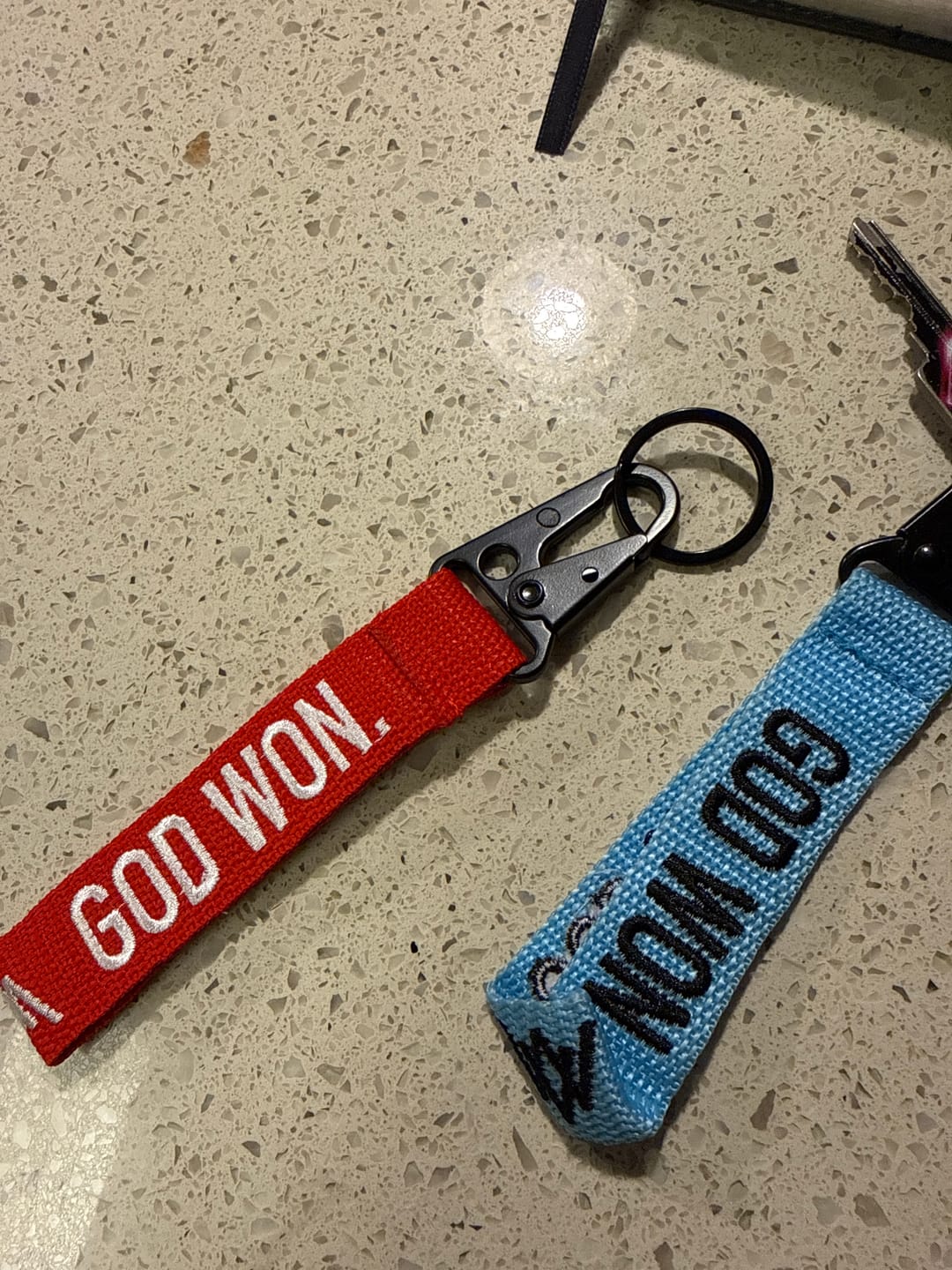 Customer photo review of ‘God Won’ Embroidered Keychain