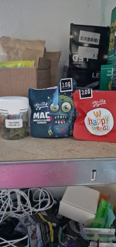 Customer's Gary Payton 31% THCA in its clear jar with visible buds, sitting on a shelf next to other packaged products.