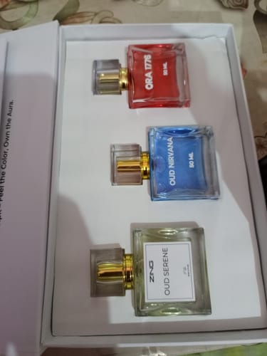 Customer's photo of a white box with three colorful perfume bottles from their order.