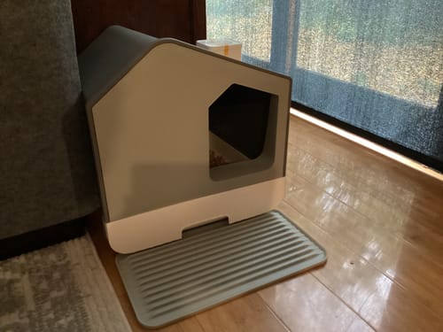 Customer's grey House Cat Litter Box set up on a wooden floor with the litter-catching tray in front.