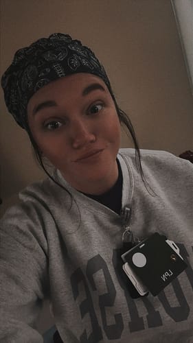 Reviewer wearing the black and white anatomy-patterned DuoStyle Scrub Hat.