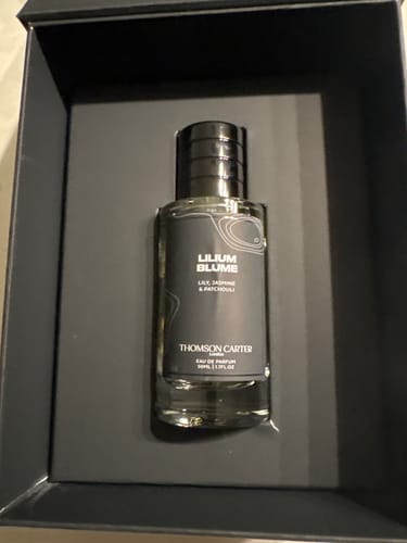 Customer's Lilium Blume Eau de Parfum bottle sitting in its sleek, black presentation box.