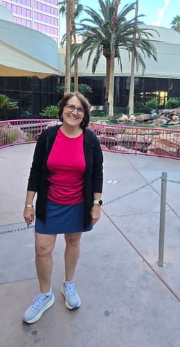Reviewer standing outdoors wearing the blue Topanga Skort with a pink top.