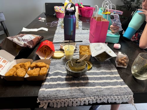 Customer's photo showing the delivered caviar being served on a table with fast food and crackers.