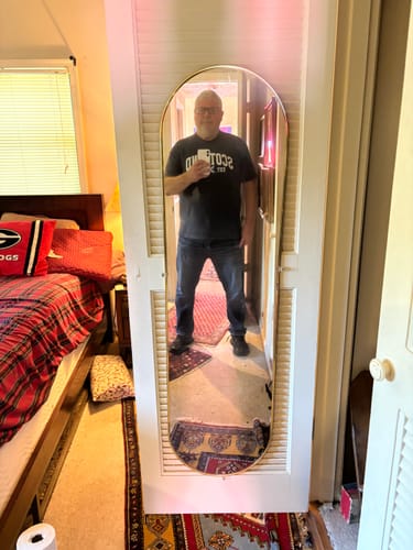 Reviewer wearing the grey Scotland Varsity Flag T-Shirt in a full-length mirror picture.