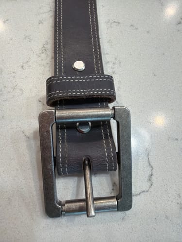 Customer's dark leather belt with a double roller buckle attached by a Tool Free Chicago Screw.
