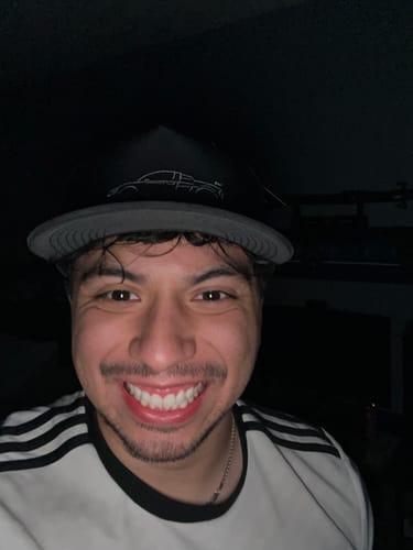 Close-up of a smiling customer wearing the black and gray 80Eighty® Limited Edition DCG89 Hat.