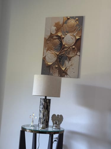 Customer's Black and Gold Splash Wall Art hanging on a wall above a decorative side table.