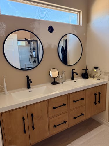 Customer's Belgian Floating Vanity in a light wood finish, installed in their bathroom during a renovation.