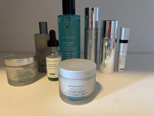 Customer's SkinCeuticals Emollience moisturizer displayed on a counter with several other skincare products.