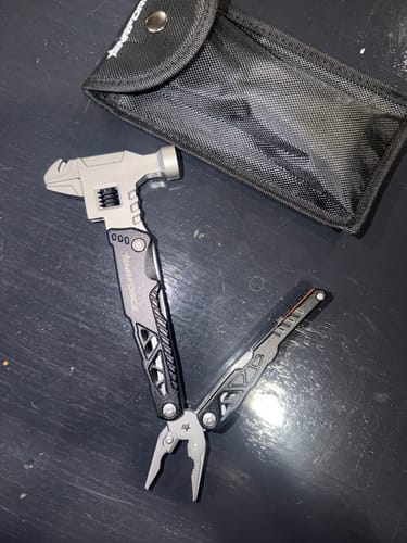Reviewer's Multi-Tool Hammer partially unfolded to show the pliers and hammer head, next to its black carrying pouch.