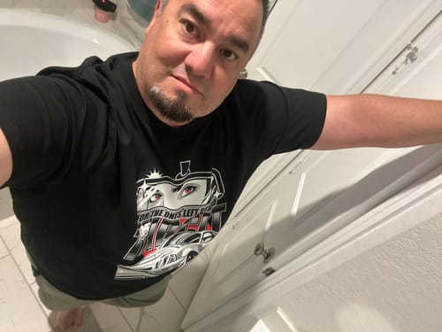 Customer takes a high-angle selfie wearing the black LEFT BEHIND TEE.