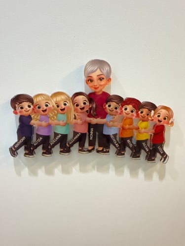 Customer's personalized acrylic magnet with a grandma figure hugging eight child figures, each with a small name printed on the leg.