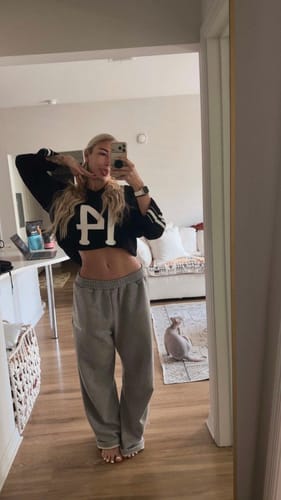 Reviewer taking a mirror selfie wearing the black W4001 Crochet Jersey styled as a crop top.