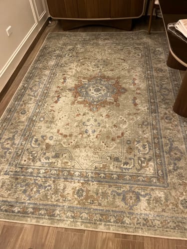 Customer's Sunset Artisan Chenille Rug with an intricate, traditional pattern laid out on a wooden floor.