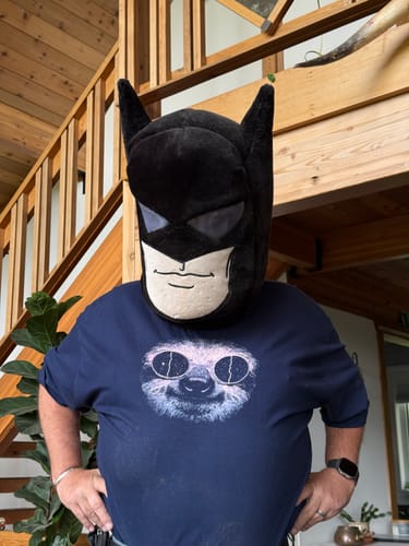 Reviewer wearing the blue Orbiting Elsewhere - Tall t-shirt with a sloth graphic.