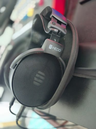 Customer's HEDD Audio HEDDphone D1 headphones with a custom strap, shown resting against their case.
