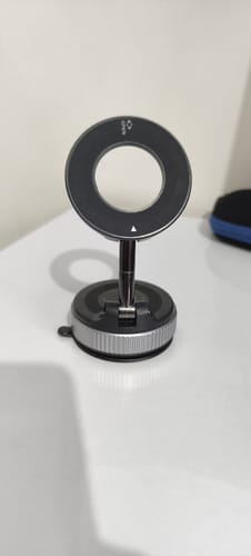 Customer's black and silver MagPro Magnetic Phone Holder standing on a white table, showing its suction base.