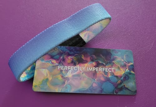 Customer's Perfectly Imperfect Bracelet showing its light blue outer side next to the matching colorful card.