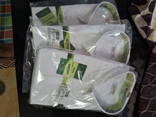 Customer's newly purchased Double Delight White Shirts, shown folded and stacked in their original packaging.