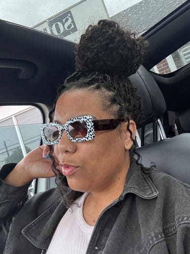 Customer wearing the rectangular Spot Me If You Can Mixed Print Sunglasses inside a car.