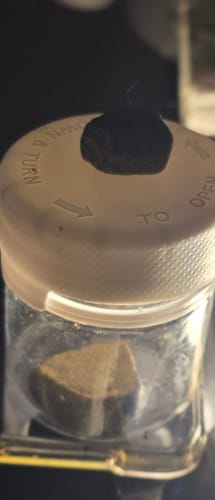 Customer's close-up of Golden Mousse in a small jar with a piece on the lid, showing its crumbly texture.