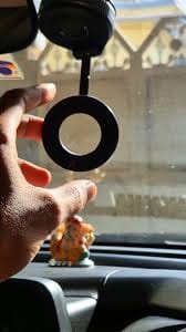 Reviewer showing the 360° MagPro Magnetic Phone Holder's circular magnetic mount inside a car.