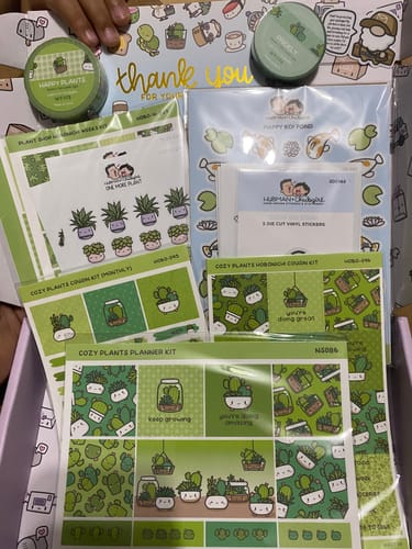 Customer's Cozy Plants Journaling Add-on, showing multiple cute sticker sheets and washi tape in a box.