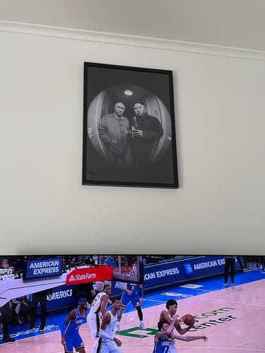 Customer's framed 'The Good Stuff' art print hanging on a white wall above a television.