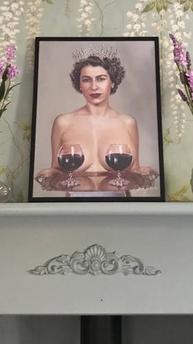 Customer's framed Majestic art print featuring a surreal portrait of a woman, displayed on a mantelpiece.