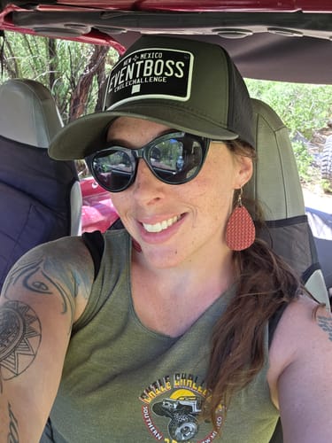 Reviewer smiling while wearing a green and black New Mexico Chiles Plate Hat with the custom text "EVENTBOSS".