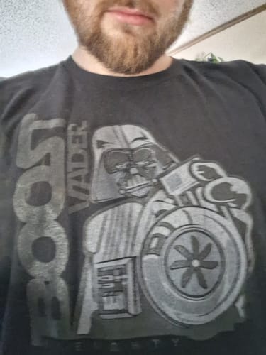 Close-up of a reviewer wearing the black BoostForce Shirt, showing the graphic of Darth Vader holding a turbo.