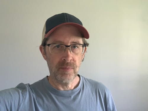 Customer's front view wearing the multi-colored Big Unstructured Trucker Hat.