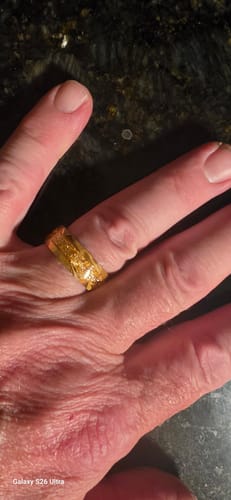 Close-up of a customer wearing the Titanfall ring, showing its bright gold flake inlay.