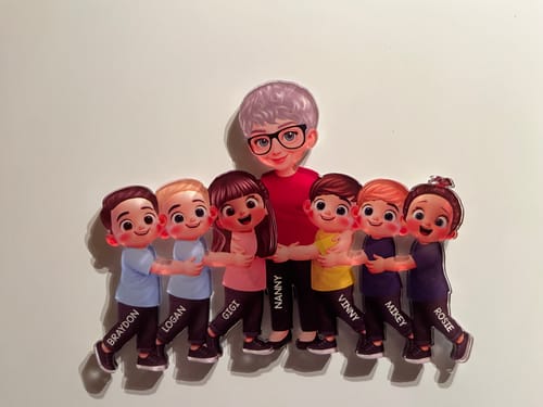 Customer's personalized acrylic fridge magnet showing a grandma figure hugging six grandkids, all with names printed on them.