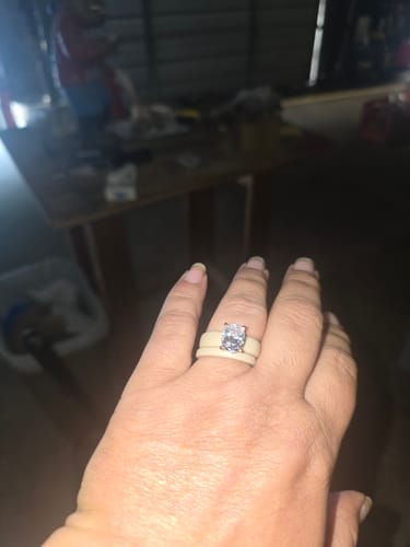 Reviewer's hand wearing the Oval Cut CZ Silicone Ring with a large stone on a light-colored band.