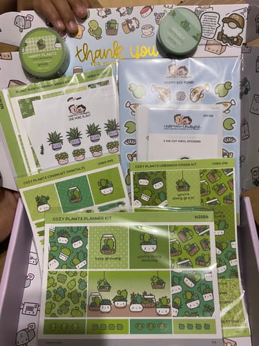 Reviewer's Calm Koi Pond Sticker Set shown in a box with other green, plant-themed sticker sheets and washi tape.